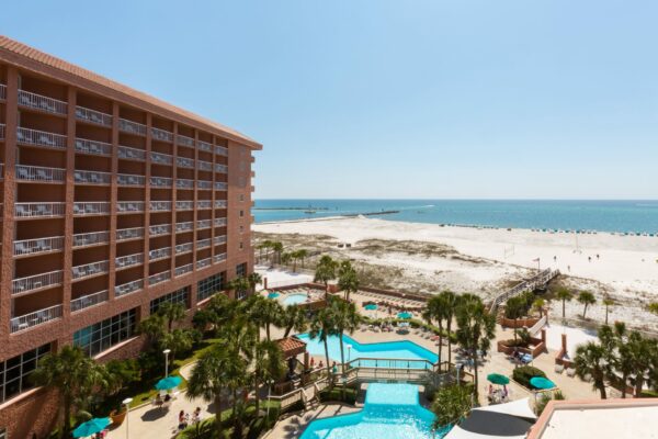 Perdido Beach Resort, with sparkling blue pools and a view of the beach